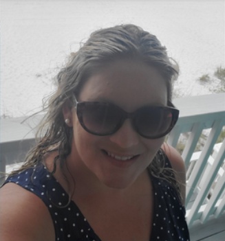 Amber Gray smiling outdoors, from her public Facebook cover